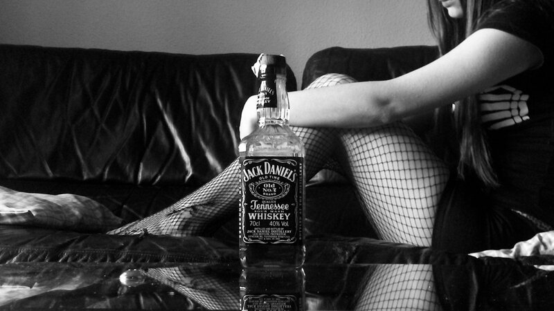 Woman in Fishnet Stockings — Black, Dramatic, Photograph, Whiskey Bottle
