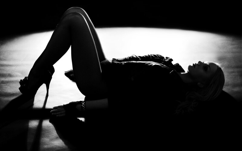 woman in fishnet stockings lying down