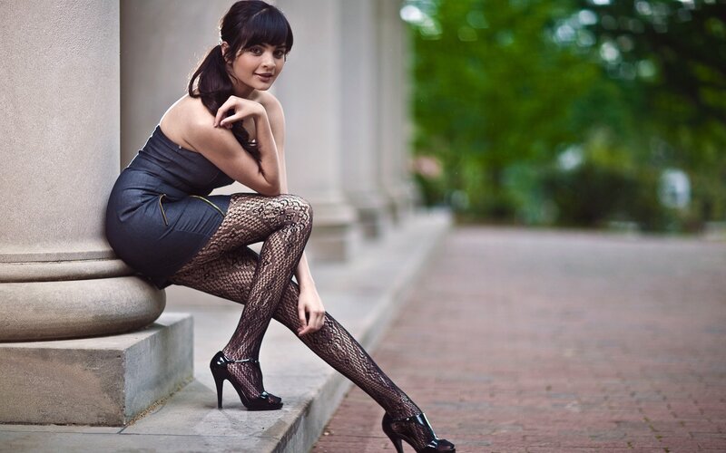 woman in fishnet tights sitting
