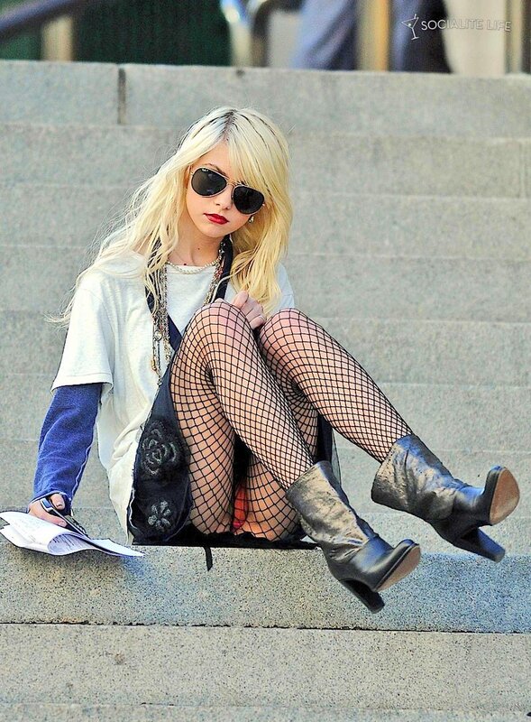 woman in fishnet tights sitting on steps