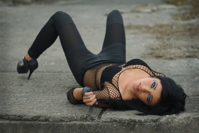 woman in fishnet top lying on ground
