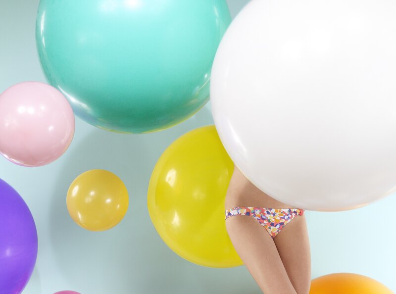 woman in floral bikini with balloons