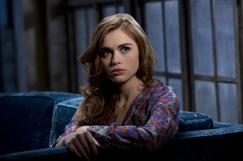 woman in floral blouse on couch