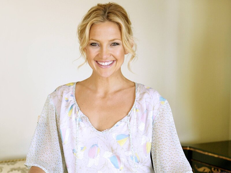 woman in floral blouse smiling
