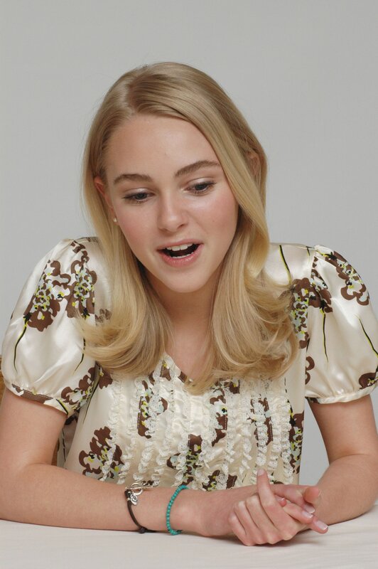 woman in floral blouse speaking