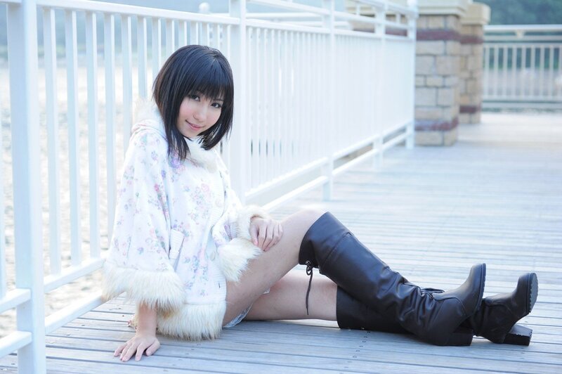 Woman in floral coat sitting on deck
