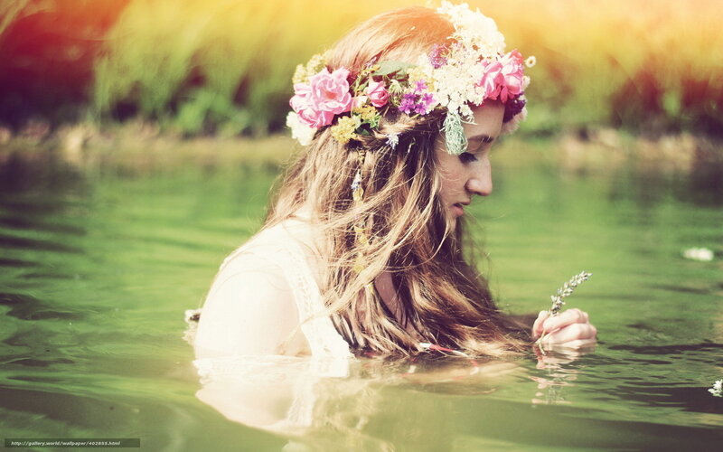 woman in floral crown by water