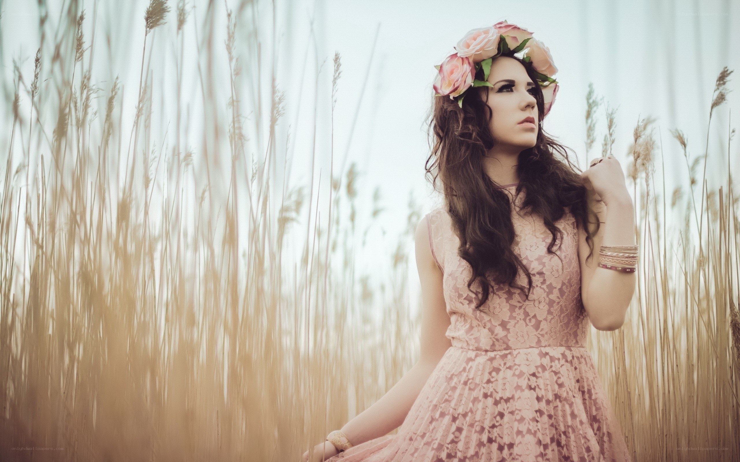 Woman in floral crown in field