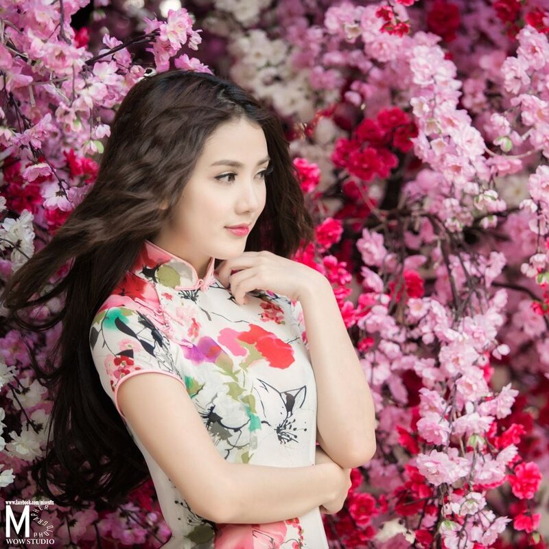 woman in floral dress among blossoms