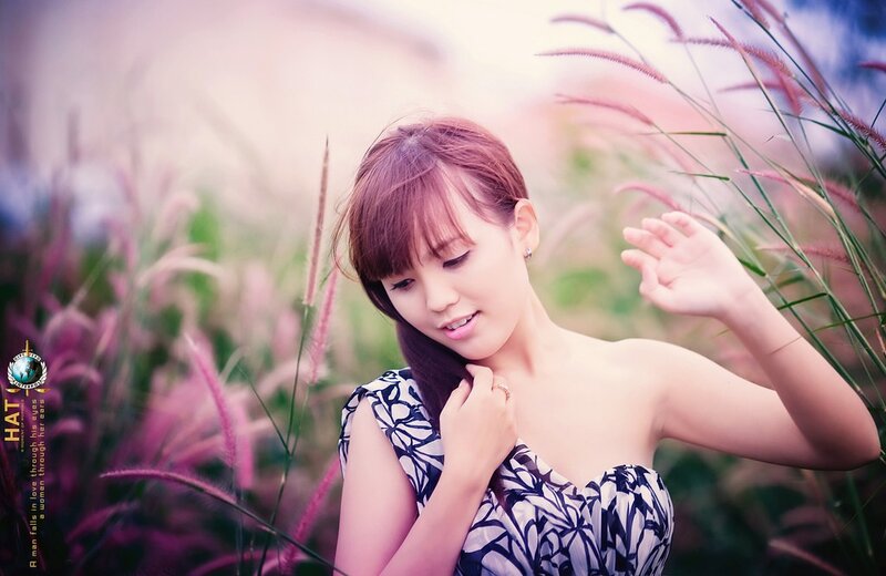 woman in floral dress among grass