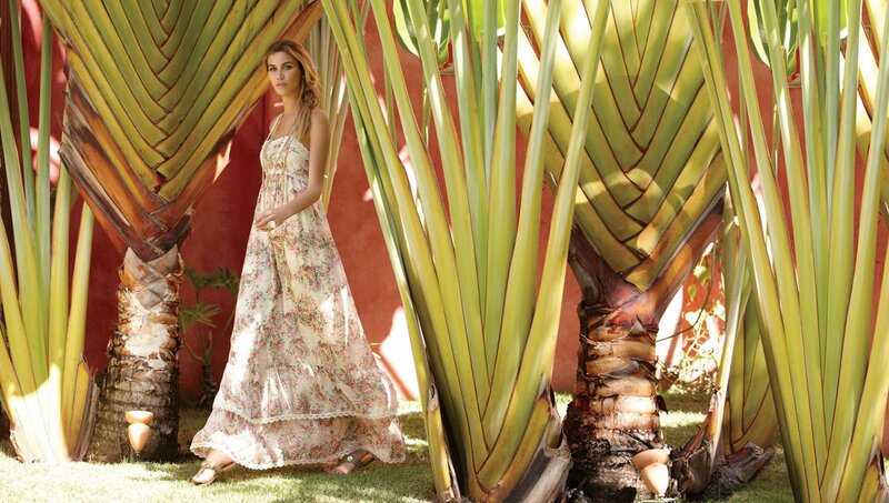 Woman in floral dress among palms