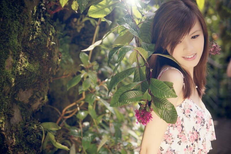 woman in floral dress among plants