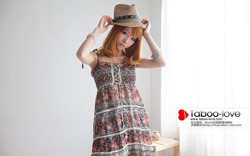 Woman in floral dress and hat