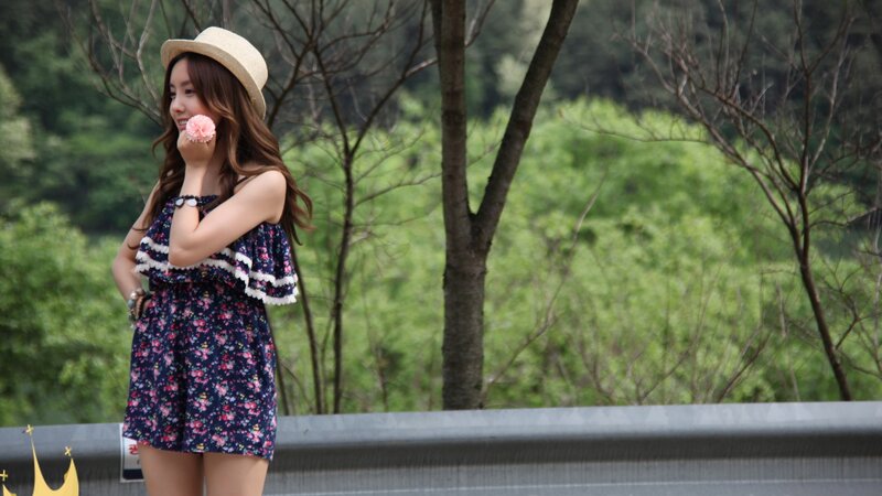 woman in floral dress and hat