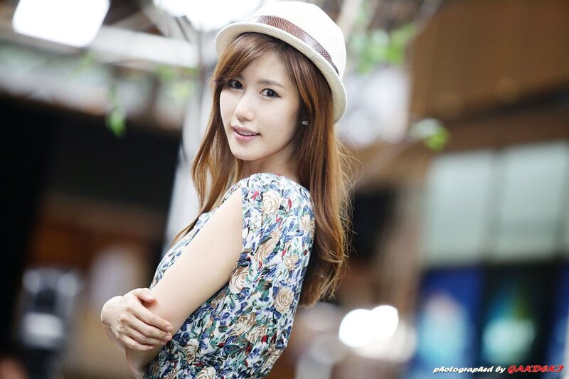 woman in floral dress and hat