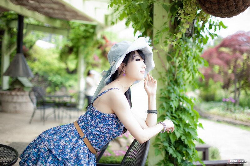 woman in floral dress and hat