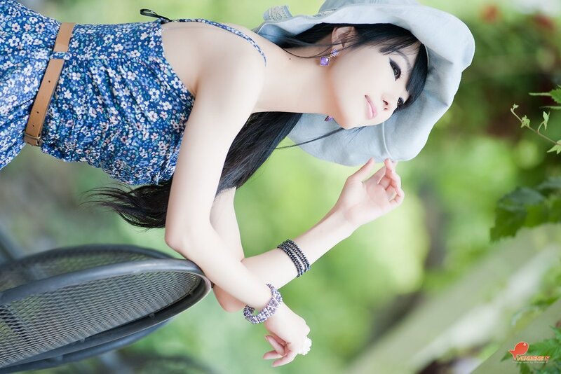 woman in floral dress and hat