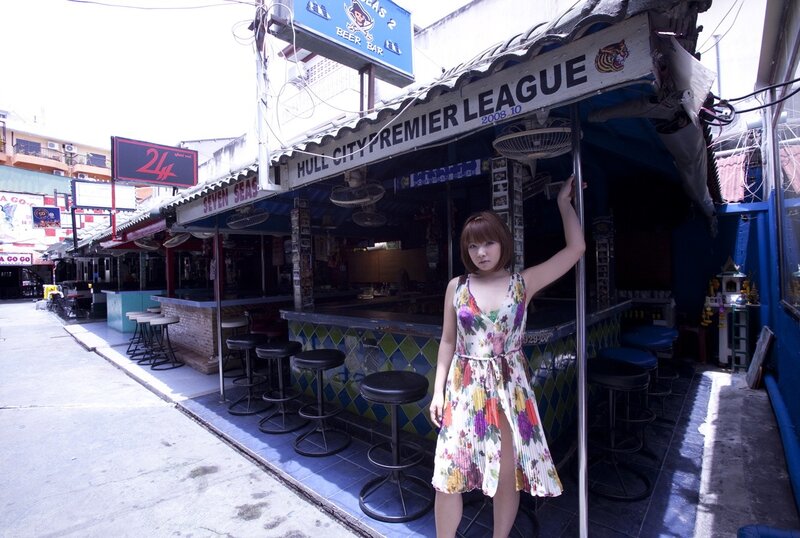 Woman in floral dress at bar