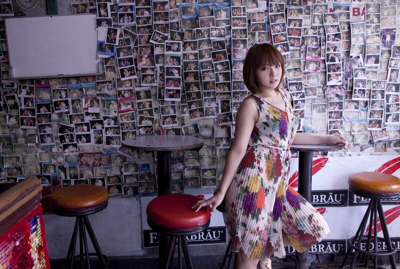 Woman in floral dress at bar