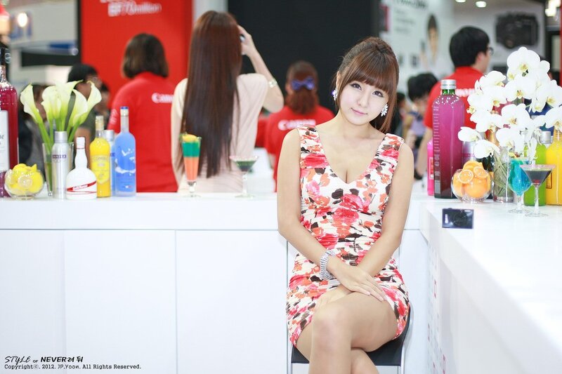 Woman in floral dress at bar