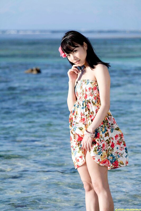 Woman in floral dress at beach