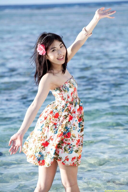 Woman in floral dress at beach