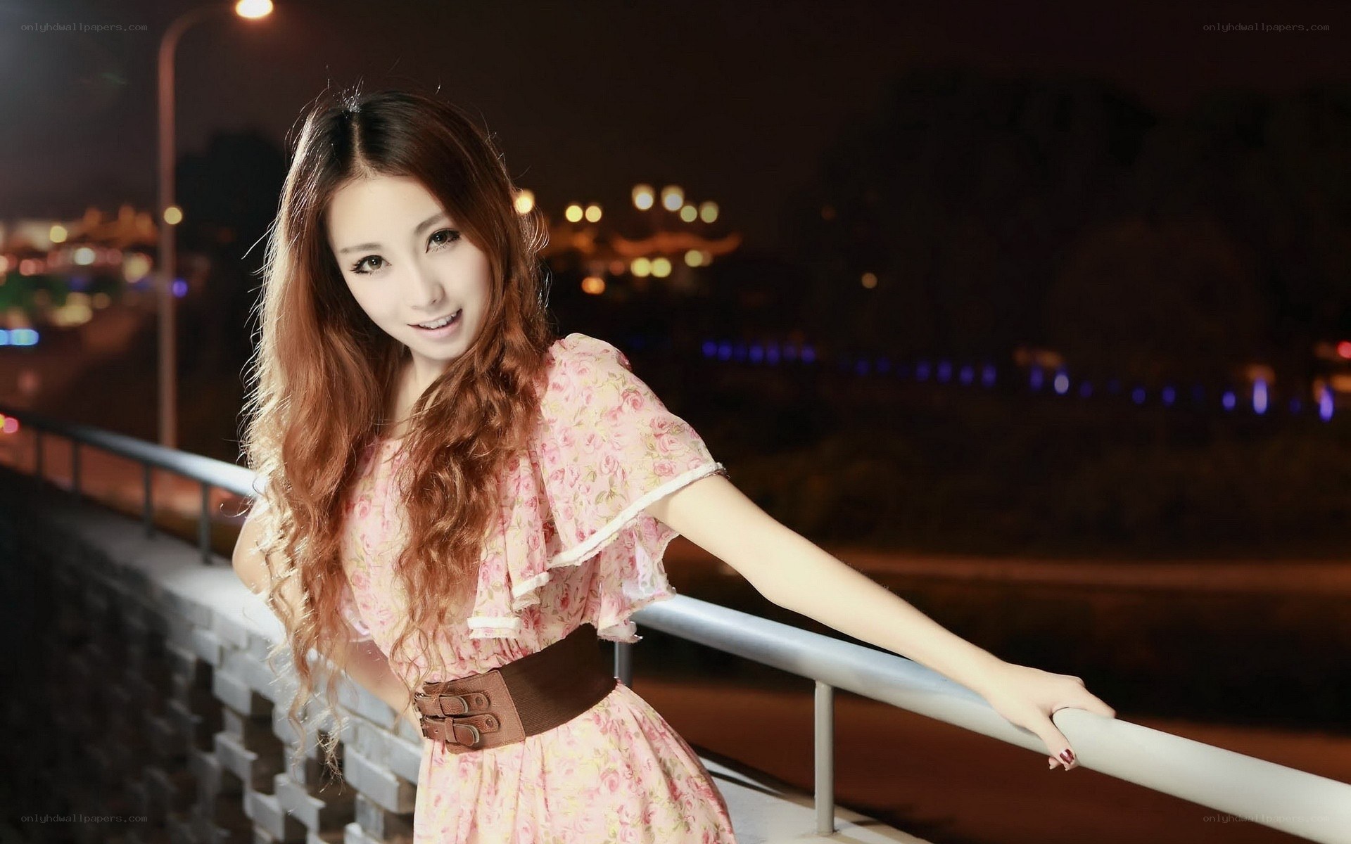 Woman in floral dress at night