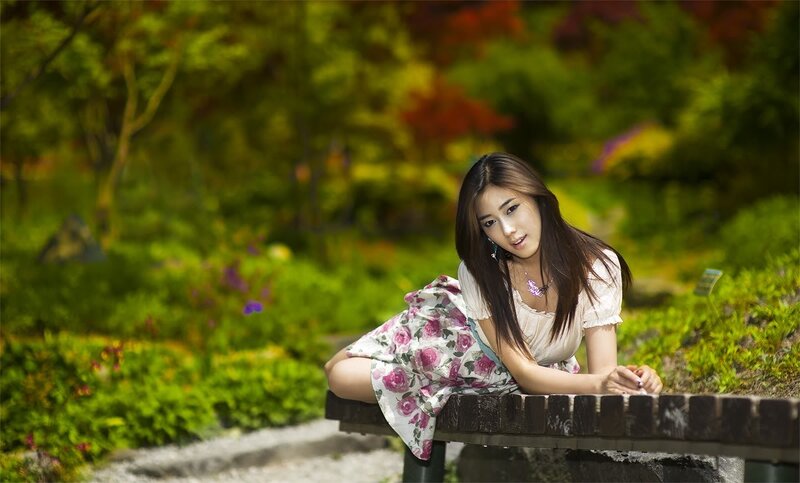 woman in floral dress at park