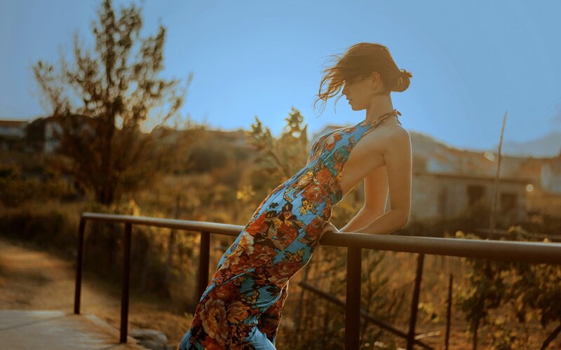 woman in floral dress at sunset