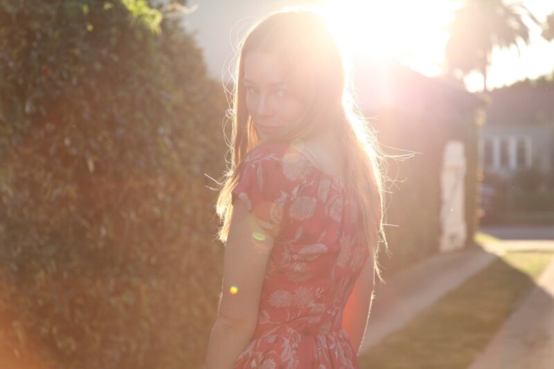 woman in floral dress at sunset