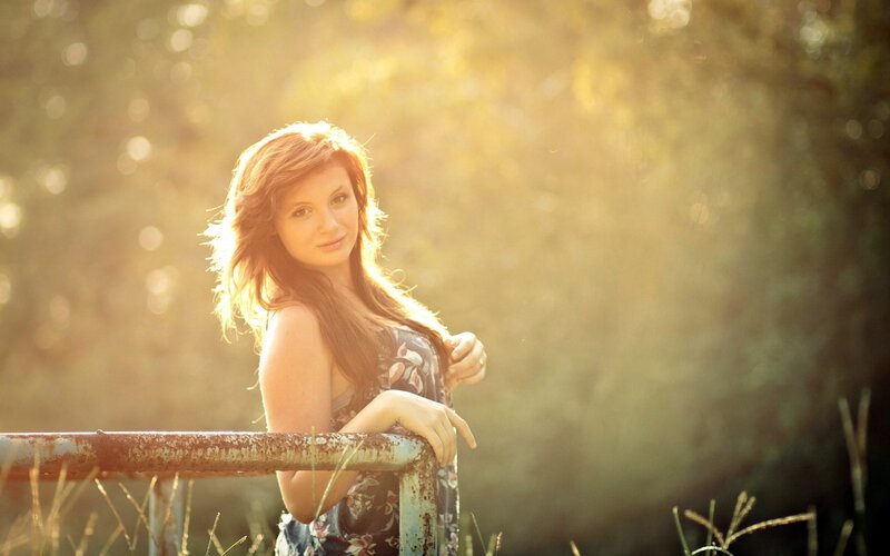 woman in floral dress at sunset