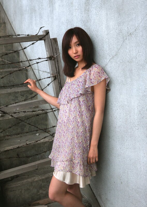 Woman in floral dress by barbed wire
