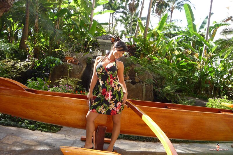 Woman in floral dress by canoe