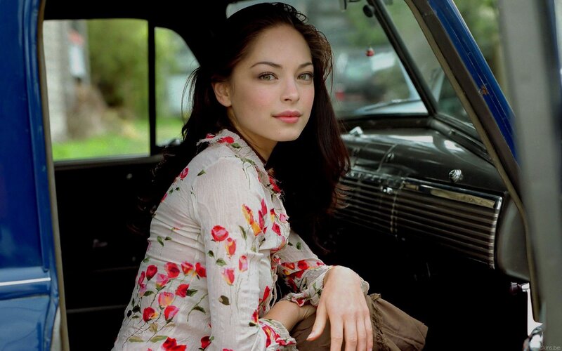 woman in floral dress by car