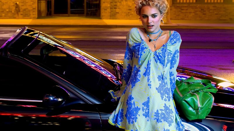 woman in floral dress by car