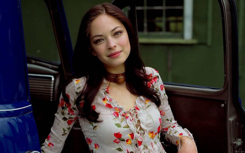 woman in floral dress by car