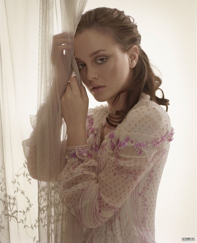woman in floral dress by curtain
