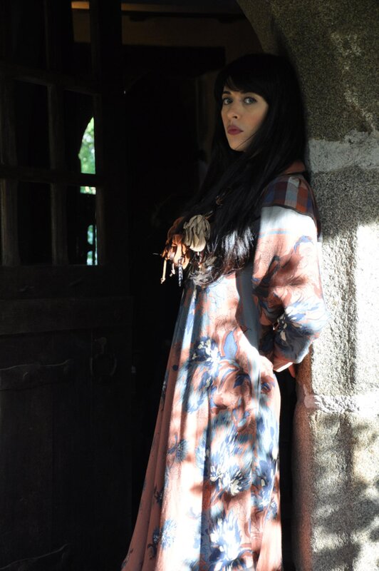 woman in floral dress by doorway