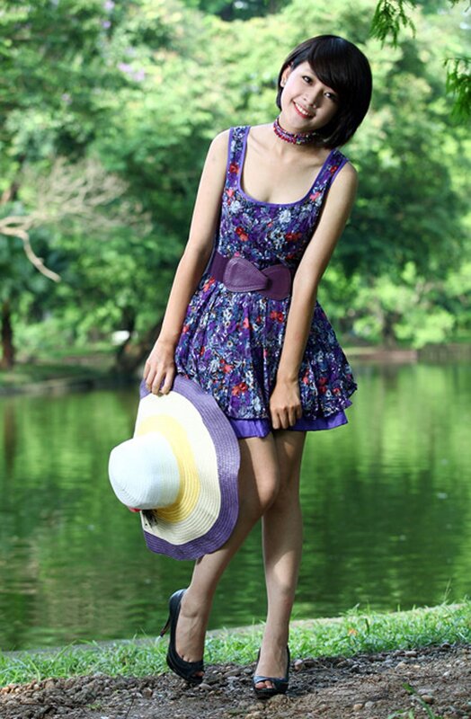 Woman in floral dress by pond