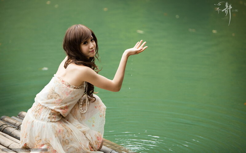 woman in floral dress by water