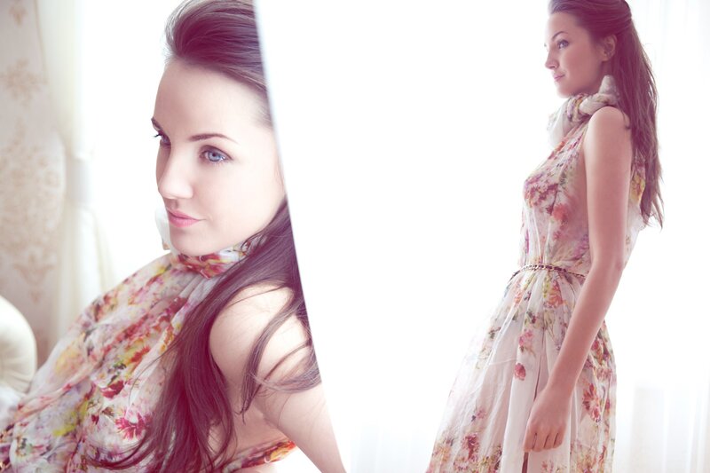 woman in floral dress by window