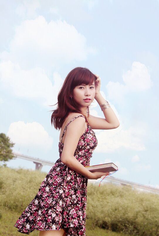 Woman in floral dress holding book