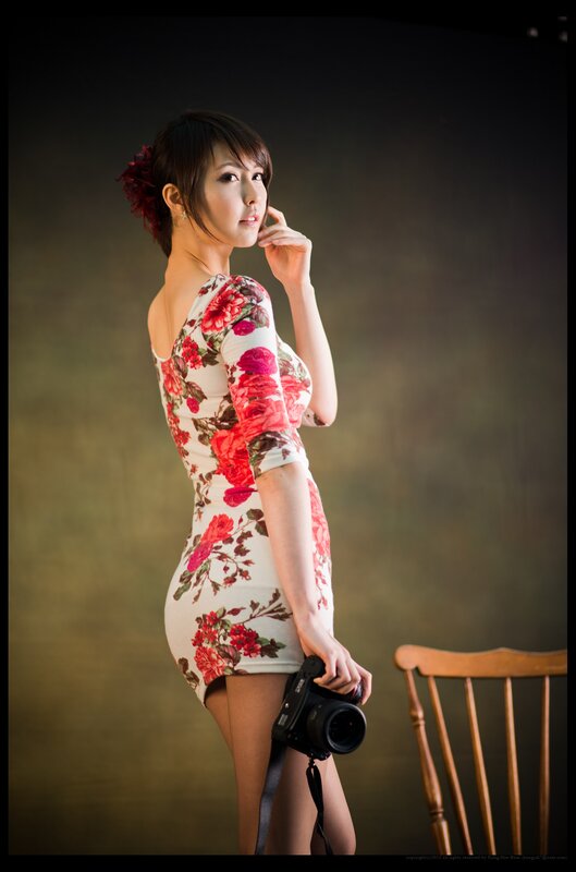 woman in floral dress holding camera