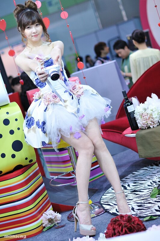 Woman in floral dress holding camera