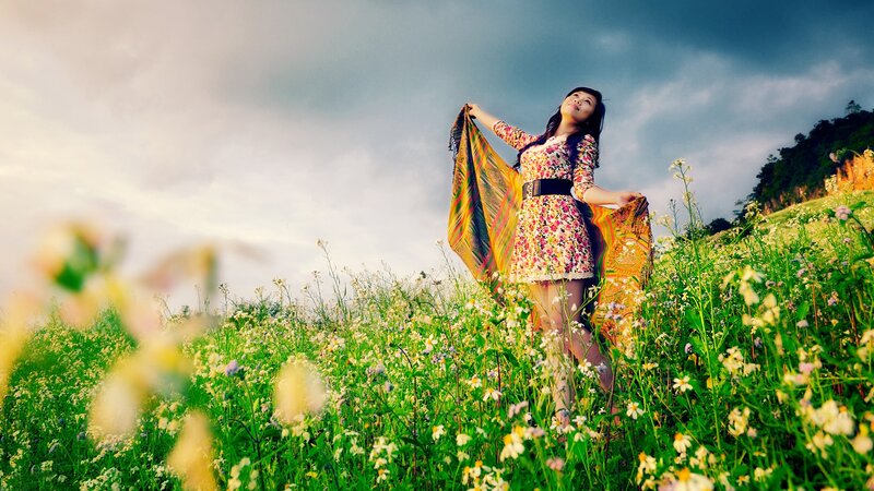 Woman in floral dress in a field