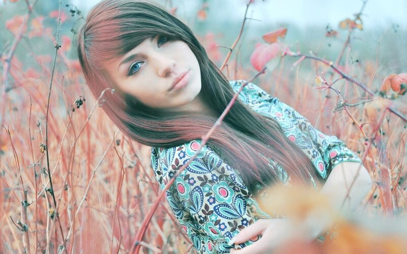 woman in floral dress in autumn field