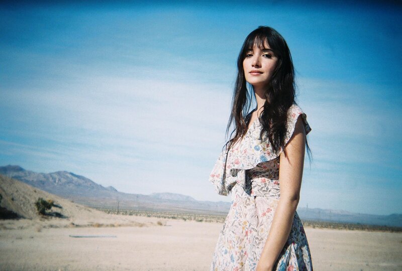 woman in floral dress in desert