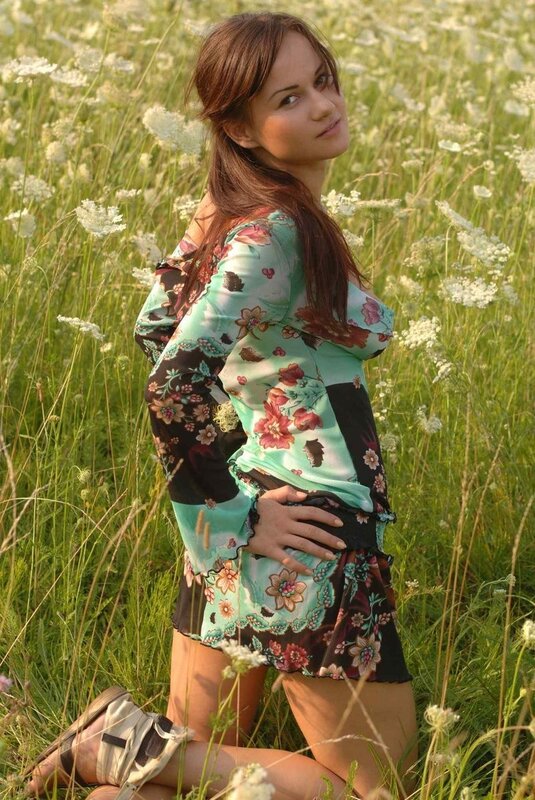 Woman in floral dress in field