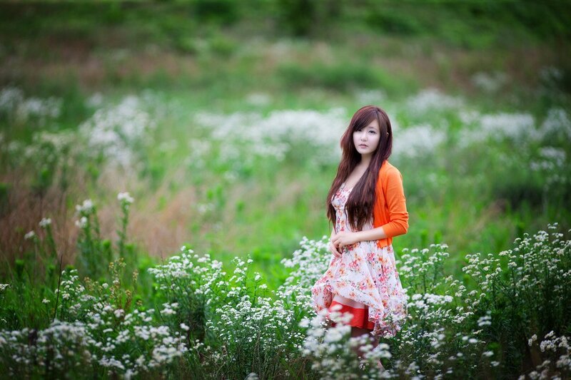 Woman in floral dress in field