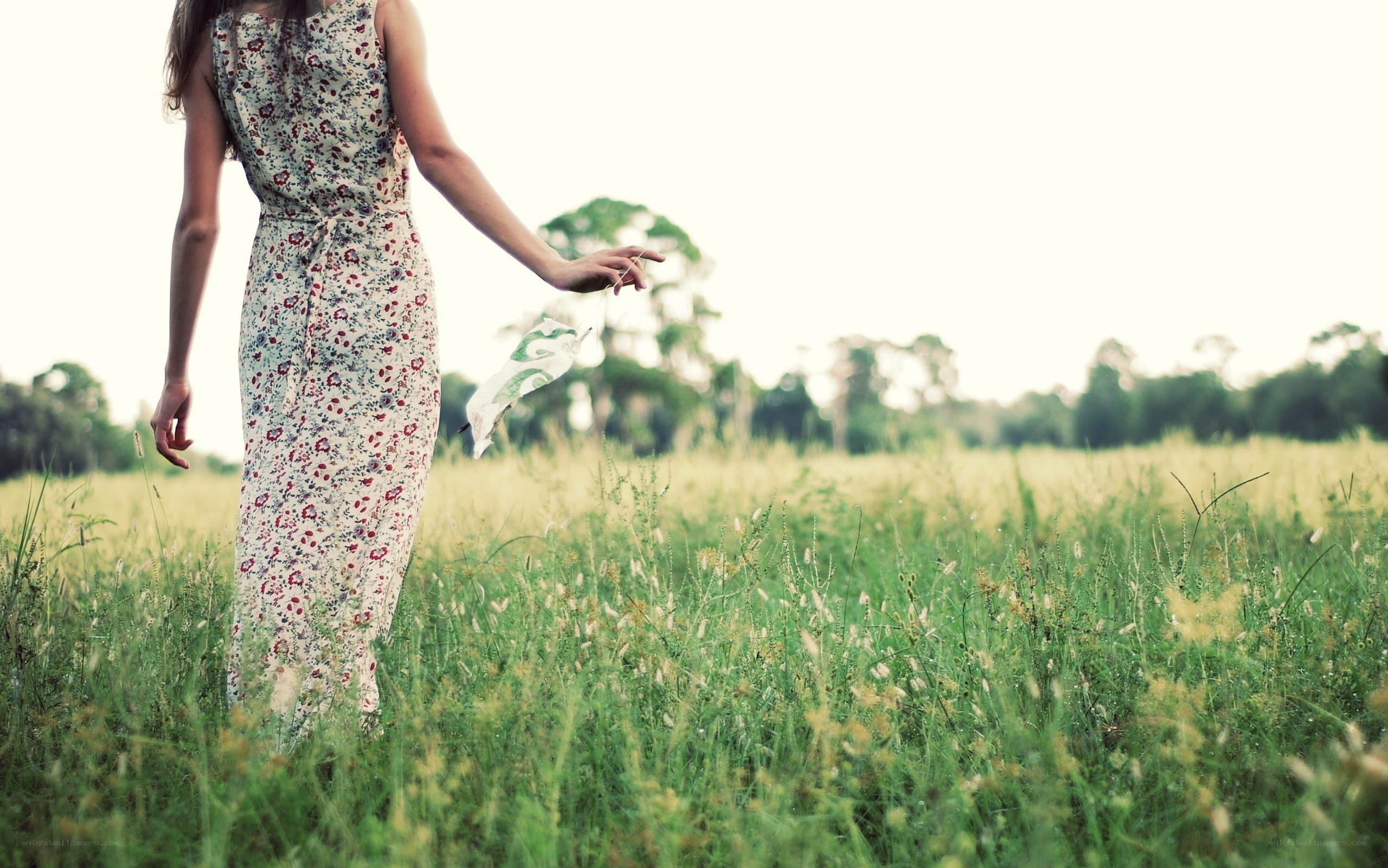 Woman in floral dress in field